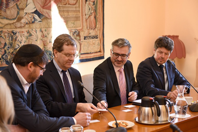 Photo of David Harris leading an AJC delegation in a meeting with Czech Deputy Foreign Minister Václav Kolaja